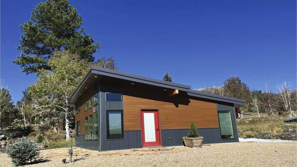Modern modular home beside a landscaped yard